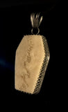 Item 8. Human skull cap coffin pendant