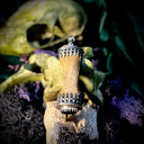 Finger bone pendant with onyx eye