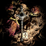 Silver key human femur pendant