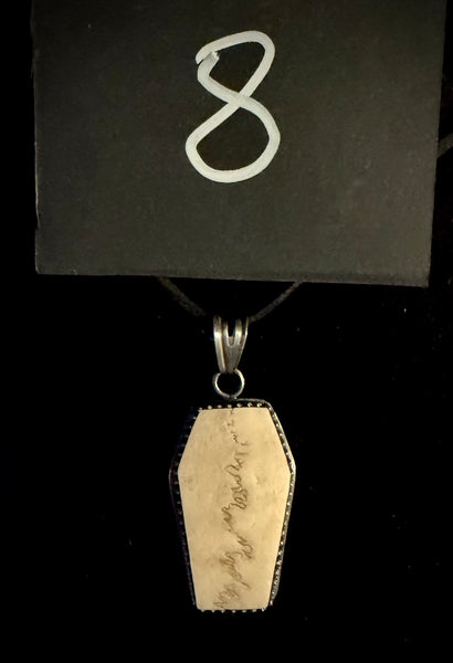 Item 8. Human skull cap coffin pendant