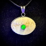 Human skull cap ‘eye’ pendant with uranium glass