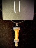 Item 11. Finger bone tooth pendant