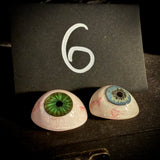 Item 6. Two vintage glass eyes