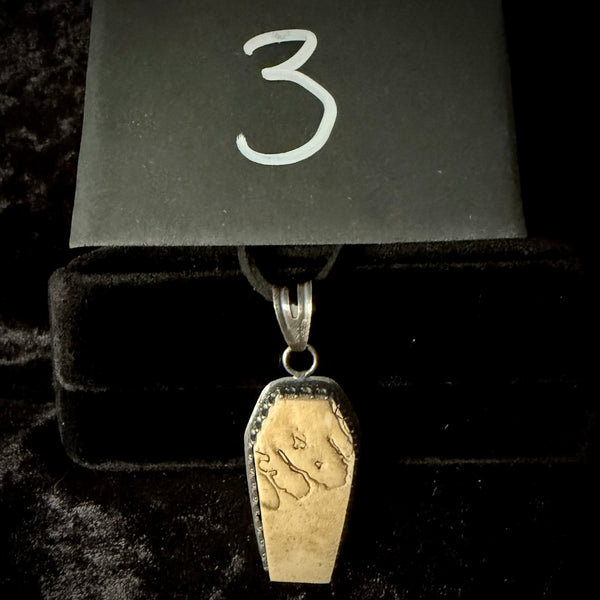 Item 3. Skull cap coffin pendant