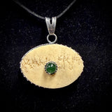Human skull cap ‘eye’ pendant with uranium glass