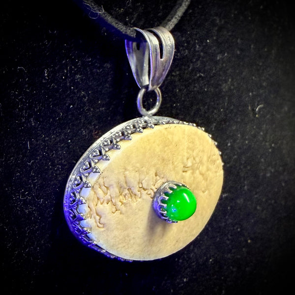 Human skull cap ‘eye’ pendant with uranium glass