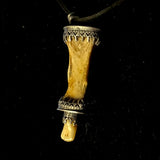Item 11. Finger bone tooth pendant