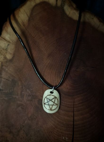 Inverted pentagram symbol burnt onto human bone necklace